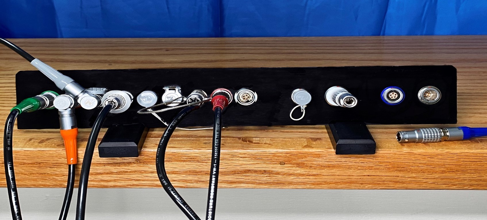 a panel full of a variety of colors and types of lemo bend relief accessories and plugs